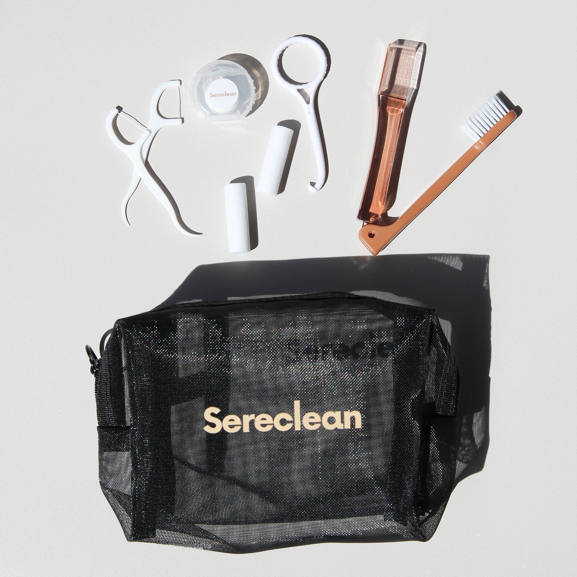 Sereclean aligner travel kit showing floss, chewies, foldable toothbrush and aligner hook